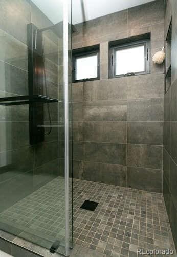 9768 Otis Dr, Westminster, CO 80021 - full bath featuring tile patterned flooring and a stall shower