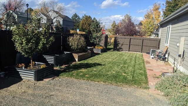 9768 Otis Dr, Westminster, CO 80021 - view of yard with a garden and a fenced backyard