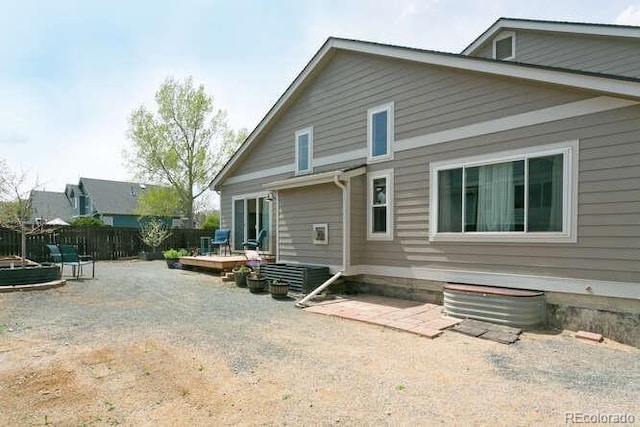 9768 Otis Dr, Westminster, CO 80021 - rear view of property featuring fence and a wooden deck