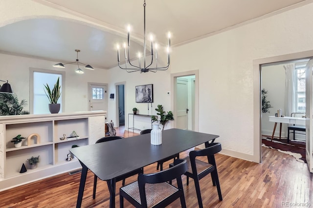 dining area with light wood-type flooring, baseboards, visible vents, and ornamental molding