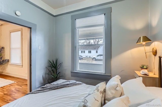 bedroom with wood finished floors and baseboards