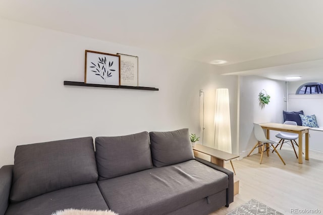 living room featuring light wood finished floors and baseboards