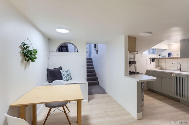 interior space with light wood finished floors and a sink