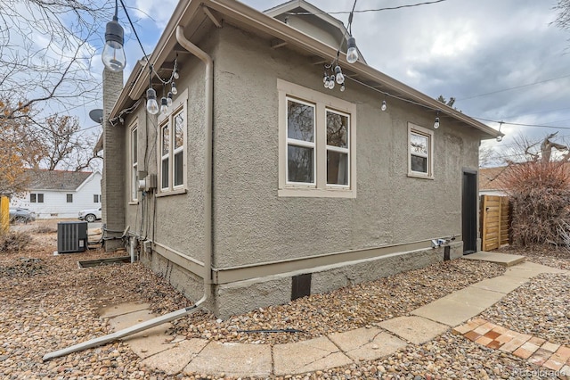 view of home's exterior with central AC unit and stucco siding