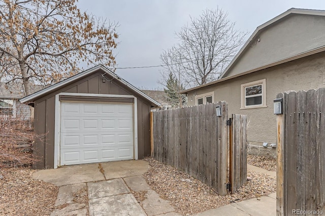 detached garage with driveway and fence