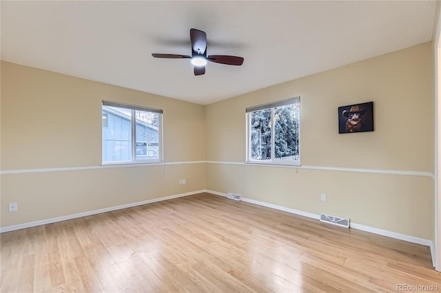 spare room featuring light wood-type flooring and ceiling fan