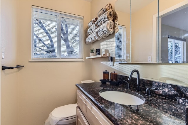 bathroom featuring vanity and toilet