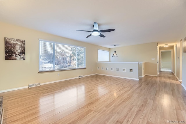 unfurnished living room featuring ceiling fan and light wood-type flooring