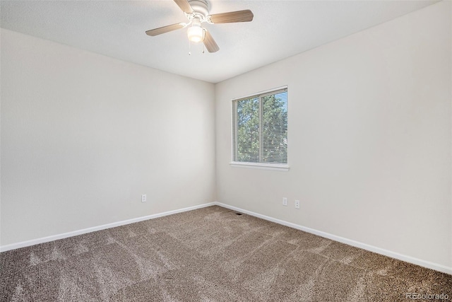 carpeted spare room with ceiling fan