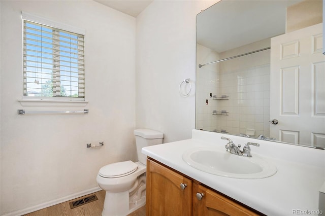 bathroom with hardwood / wood-style floors, vanity, and toilet