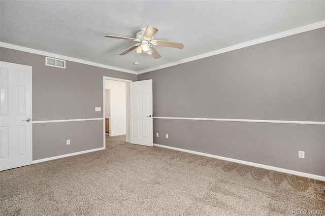 carpeted spare room featuring a textured ceiling, ceiling fan, and ornamental molding