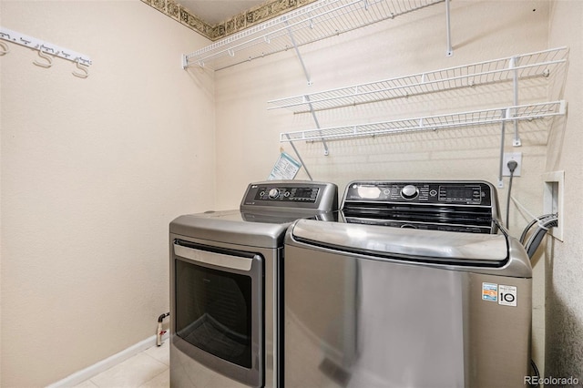 washroom featuring independent washer and dryer and light tile patterned flooring