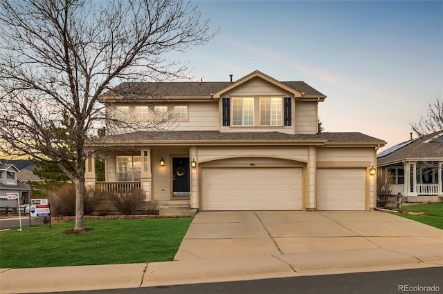 7661 Chickaree Ct, Littleton, CO 80125 - view of front facade featuring concrete driveway, a yard, covered porch, a garage, and a shingled roof