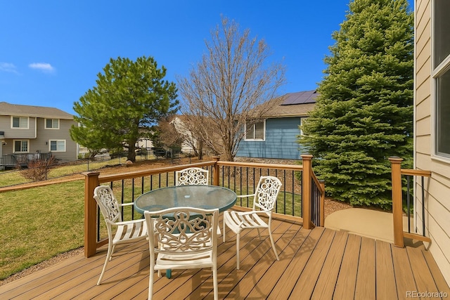 7661 Chickaree Ct, Littleton, CO 80125 - wooden deck featuring outdoor dining area and a lawn