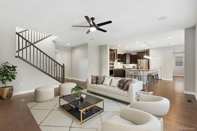 living room featuring ceiling fan and hardwood / wood-style flooring