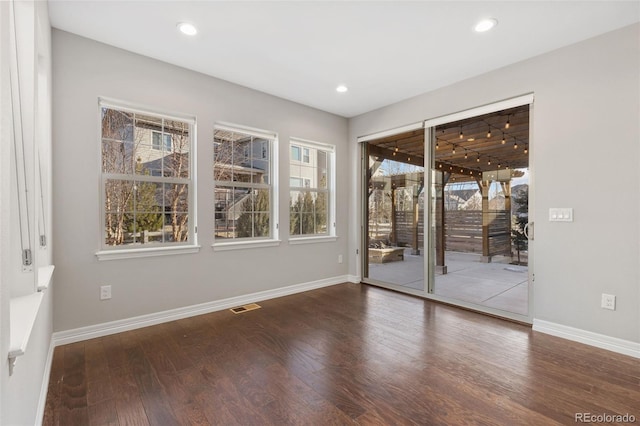 spare room featuring dark hardwood / wood-style floors