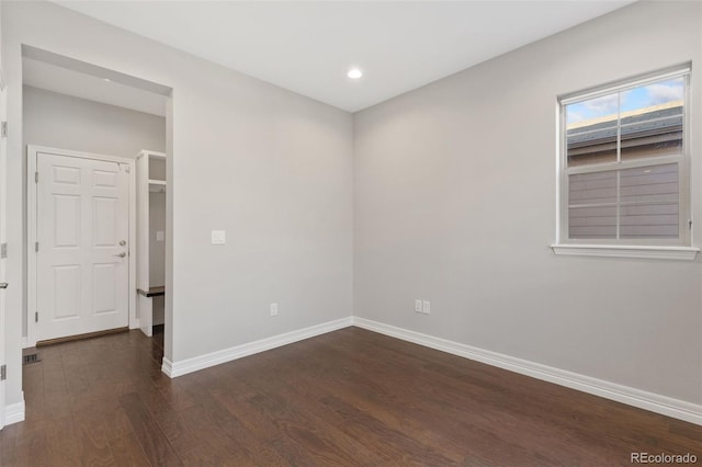 spare room with dark wood-type flooring