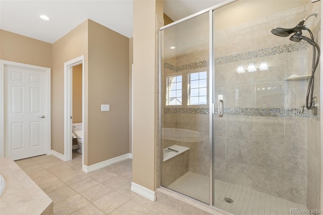 bathroom with toilet, walk in shower, and tile patterned floors