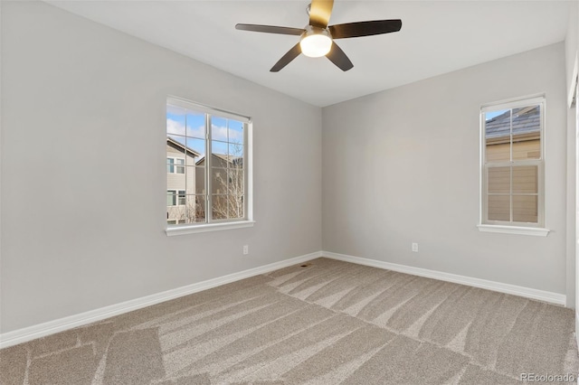 unfurnished room featuring ceiling fan and carpet