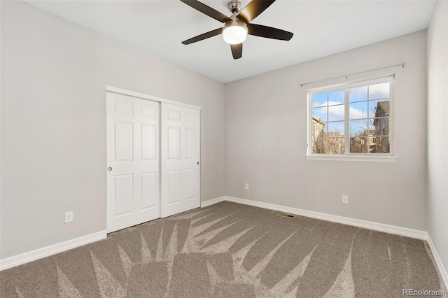 unfurnished bedroom with a closet, ceiling fan, and carpet floors