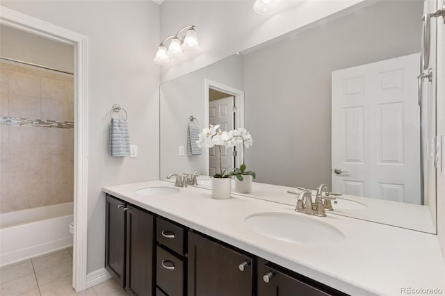 full bathroom featuring toilet, tiled shower / bath combo, tile patterned floors, and vanity