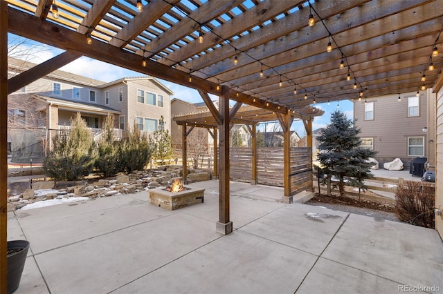 view of patio / terrace with a fire pit and a pergola