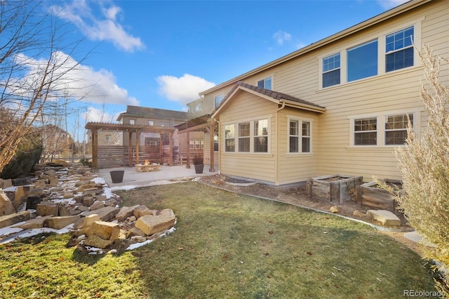 back of house with an outdoor fire pit, a patio, a yard, and a pergola