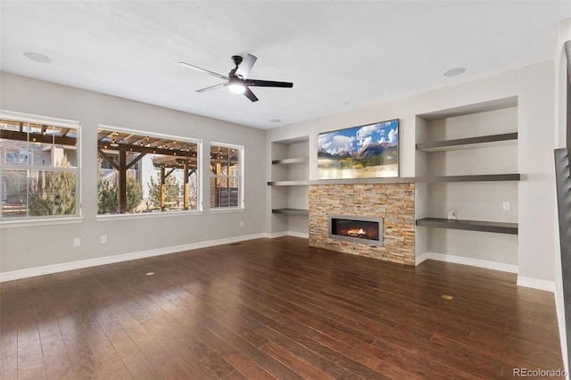 unfurnished living room with dark hardwood / wood-style flooring, a fireplace, ceiling fan, and built in features