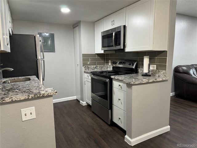 kitchen featuring dark wood-type flooring, white cabinetry, sink, and stainless steel appliances