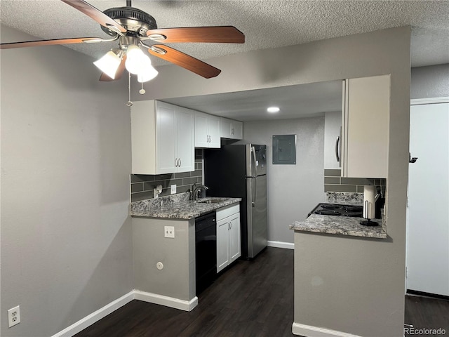 kitchen featuring backsplash, light stone counters, sink, black appliances, and white cabinetry