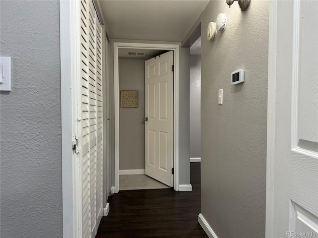 corridor featuring dark hardwood / wood-style floors