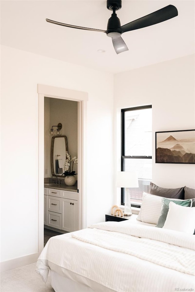 bedroom with ensuite bath and a ceiling fan