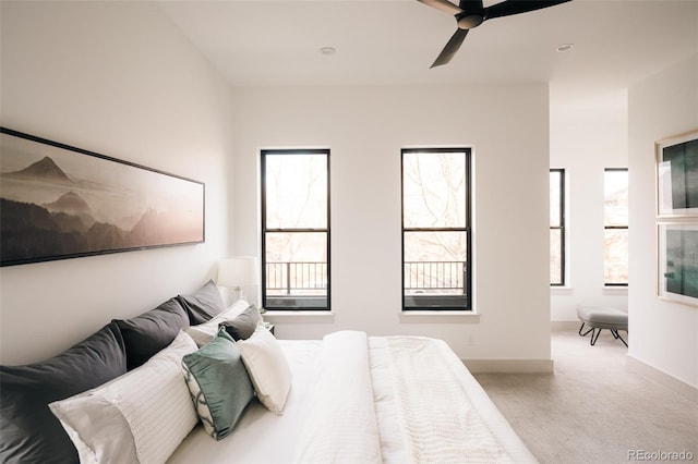 bedroom featuring baseboards, carpet floors, and a ceiling fan