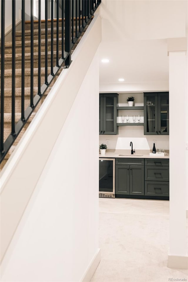 bar featuring stairway, a sink, beverage cooler, indoor wet bar, and recessed lighting