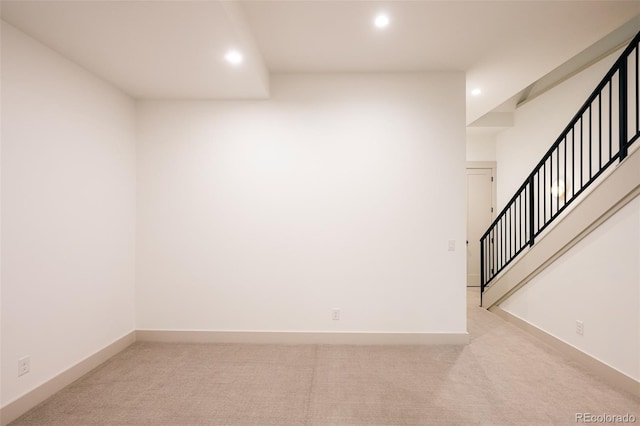carpeted spare room with stairs, baseboards, and recessed lighting