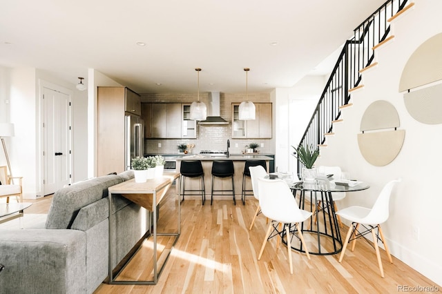interior space with baseboards, stairs, and light wood-style floors