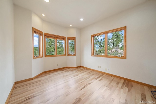 23007 Big Game Trl, Conifer, CO 80433 - empty room with healthy amount of natural light, light wood finished floors, recessed lighting, and baseboards