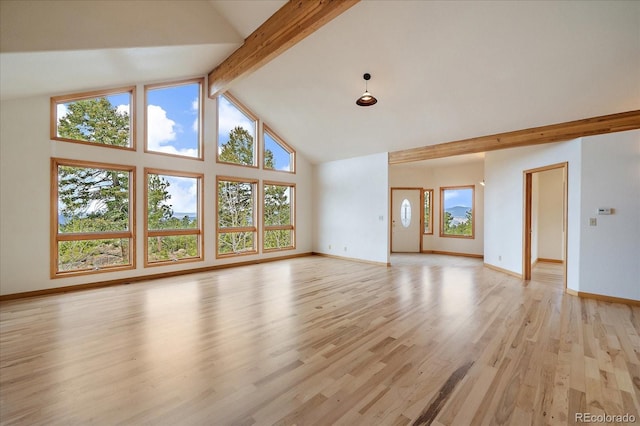 23007 Big Game Trl, Conifer, CO 80433 - unfurnished living room featuring high vaulted ceiling, beamed ceiling, light wood-style floors, and baseboards