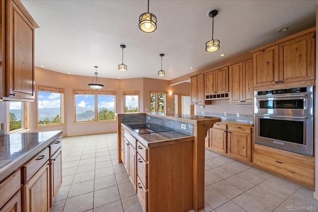 23007 Big Game Trl, Conifer, CO 80433 - kitchen with black electric cooktop, double oven, light tile patterned floors, a kitchen island, and recessed lighting