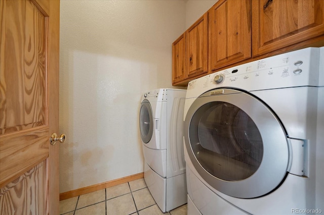 23007 Big Game Trl, Conifer, CO 80433 - washroom featuring separate washer and dryer, baseboards, cabinet space, and light tile patterned floors