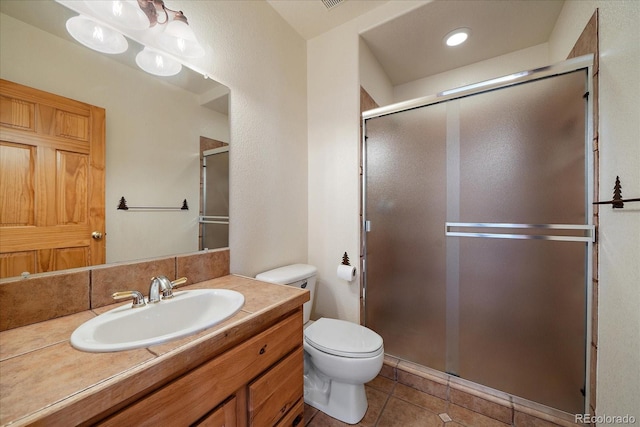 23007 Big Game Trl, Conifer, CO 80433 - full bathroom with tile patterned floors, a stall shower, toilet, and vanity
