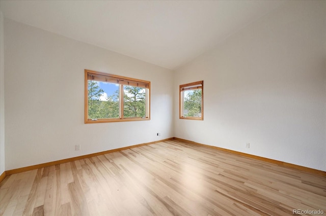 23007 Big Game Trl, Conifer, CO 80433 - empty room featuring light wood-style flooring, vaulted ceiling, and baseboards