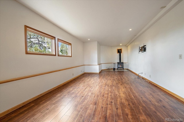 23007 Big Game Trl, Conifer, CO 80433 - empty room featuring a wood stove, hardwood / wood-style floors, baseboards, and recessed lighting