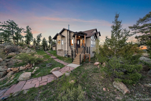 23007 Big Game Trl, Conifer, CO 80433 - view of front facade featuring stone siding, stucco siding, and a lawn
