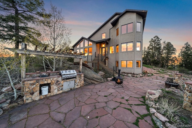 23007 Big Game Trl, Conifer, CO 80433 - rear view of property featuring a patio, stairs, area for grilling, and stucco siding