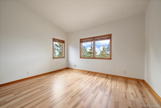 23007 Big Game Trl, Conifer, CO 80433 - unfurnished room with lofted ceiling, baseboards, and light wood-style flooring