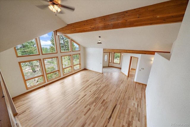 23007 Big Game Trl, Conifer, CO 80433 - unfurnished living room featuring lofted ceiling, a ceiling fan, light wood-type flooring, and baseboards