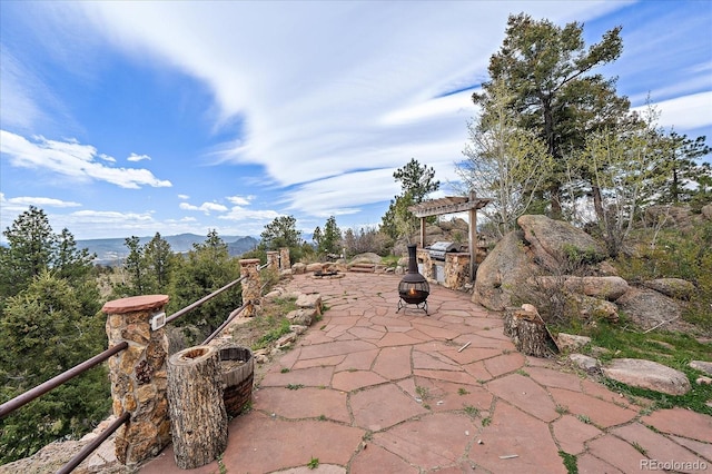 23007 Big Game Trl, Conifer, CO 80433 - view of patio with an outdoor fire pit and a mountain view