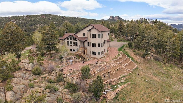 23007 Big Game Trl, Conifer, CO 80433 - view from above of property featuring a forest and a mountainous background