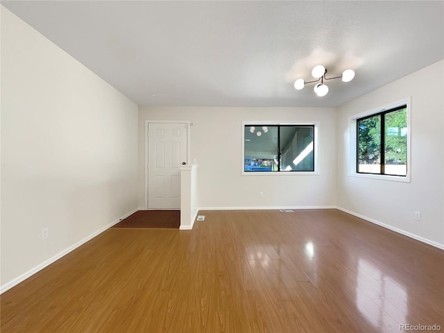 empty room with hardwood / wood-style flooring